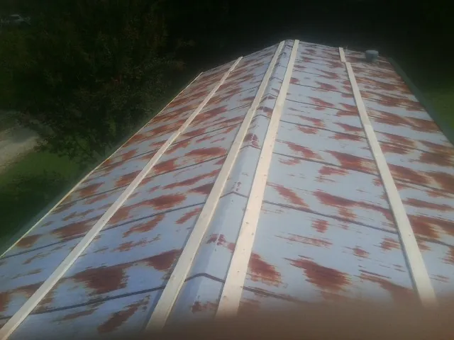 Rusted metal roof panels with new wood purlins before replacement — Storm Damage Roof Repair in Jones Mills by Roofing Brothers